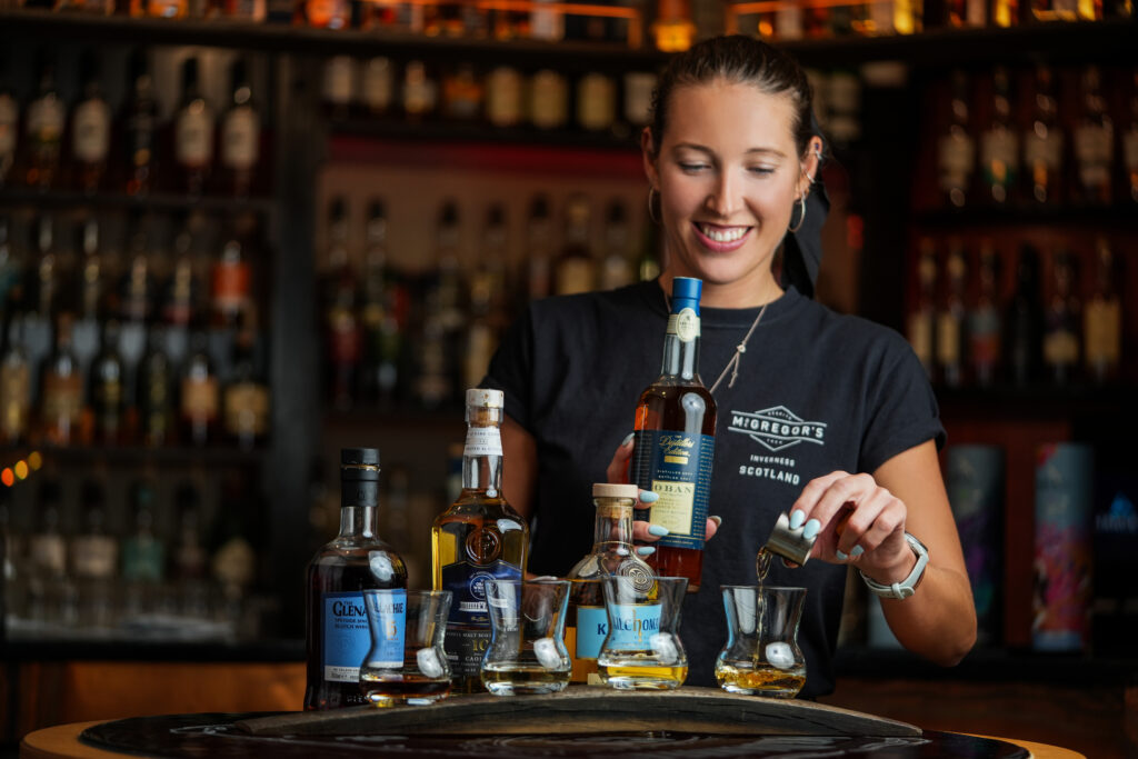 Bartender pouring whisky shots